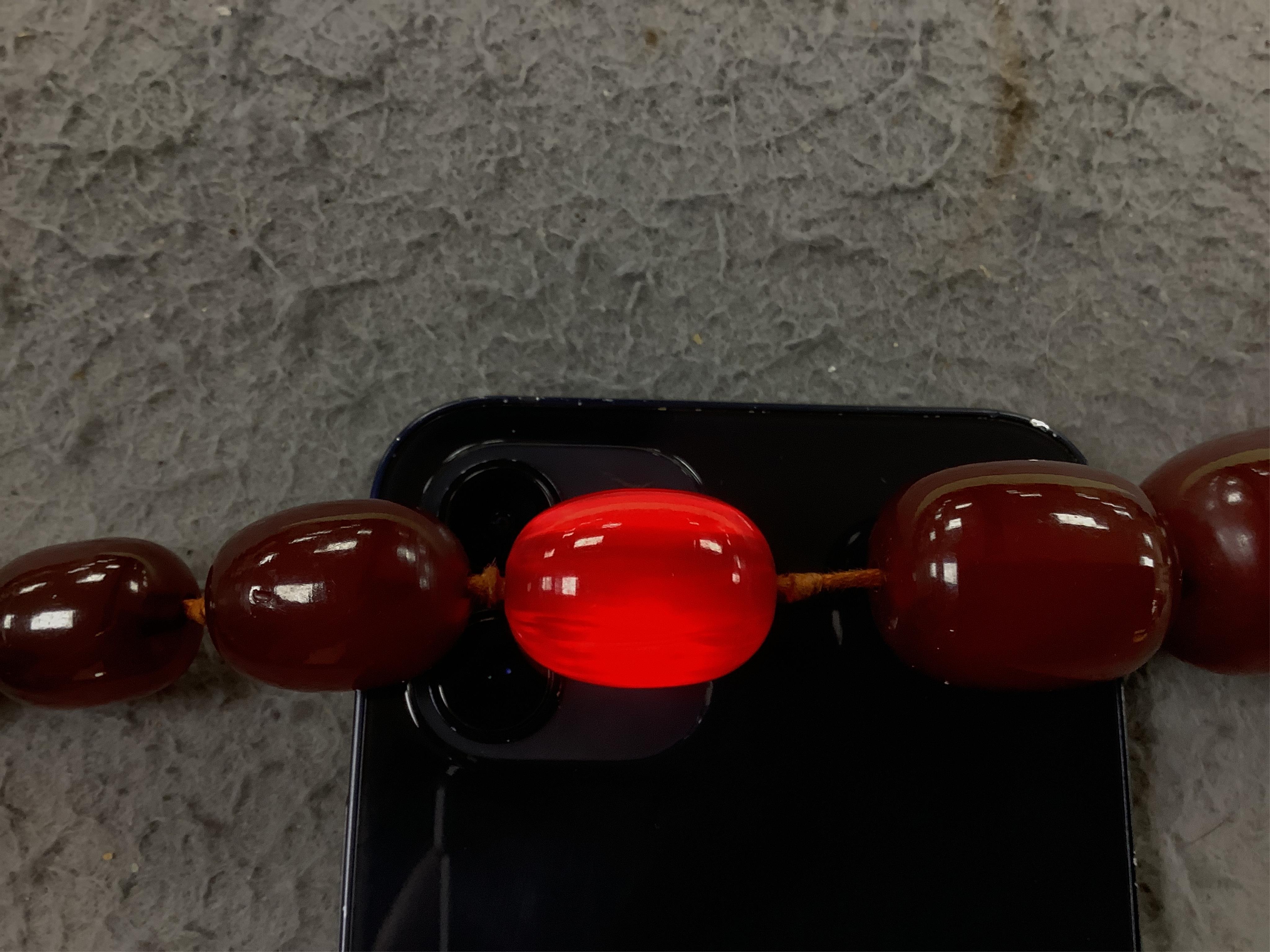 A single strand graduated simulated cherry amber necklace, 68cm gross weight 108 grams, Condition - fair